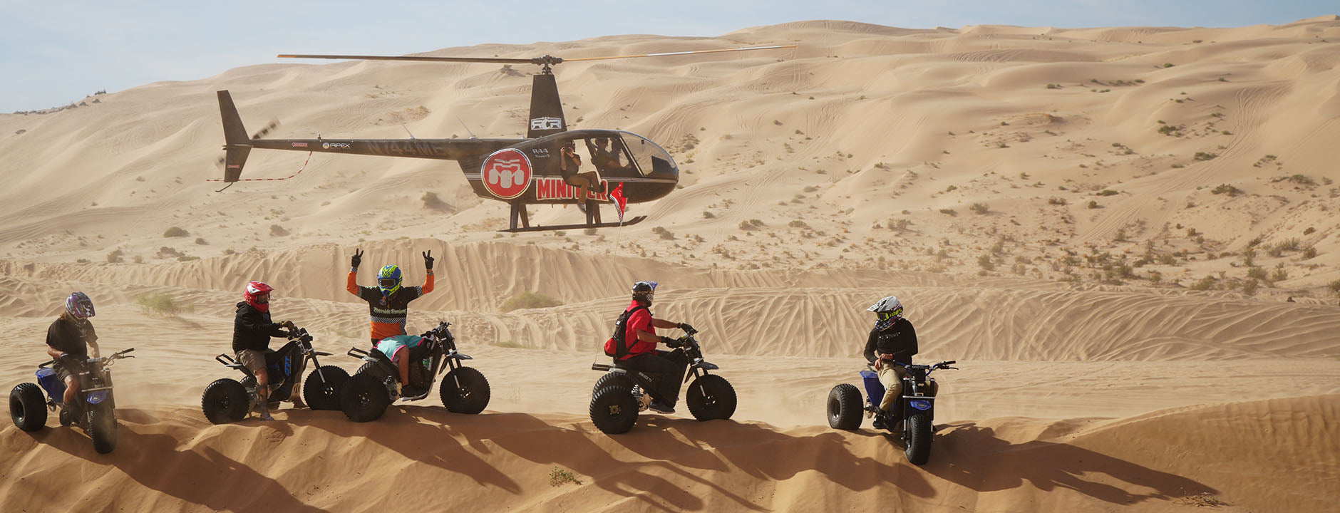 Mini RCR riders and a helicopter in the sand dunes